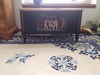 Front view of chest showing entire front panel, stenciled decoration and turned legs