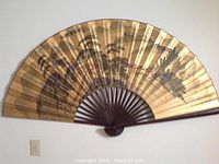 Large wood and paper wall fan showing painted Chinese landscape and calligraphy.