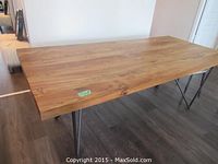 Full view of rectangular wood tabletop and hairpin legs from an angle