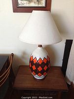 Front view of lamp with shade placed on wooden table