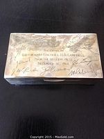 Top view showing engraved crest, inscription, and signatures