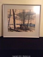 Framed watercolor painting showing a landscape with leafless trees and a body of water in the background, neutral color palette.
