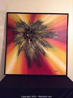 Full view of the framed square oil painting showing an abstract sunburst design with mixed media PVC pipe elements embedded in the center.