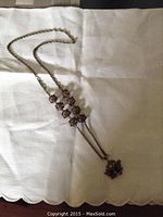 Full view of the antique silver coral bead necklace laid out flat showing its length and design.