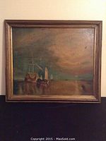 Full view of the framed oil painting showing ships at sea with a muted sunset sky reflecting in the water.