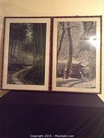 Full view of both framed Asian silk prints side by side against a wall, showing the bamboo forest and pavilion scenes.