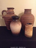 Four vintage West German pottery vases arranged in two rows showing size and glaze variations.