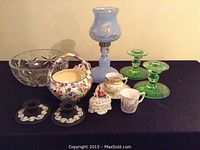 Full view of all items including bowls, lamps, candlesticks, baskets, and figurines arranged on table
