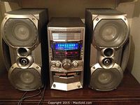 Front view of the fully assembled JVC HX-Z10 stereo system with central control unit and two speakers on either side showing overall setup and condition.