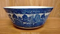 Side profile of the blue willow ceramic bowl showcasing detailed blue pattern on white base.