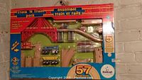 Full boxed KidKraft Track N Train Pack including all tracks, bridge, trains, and accessories, showing unopened packaging and 57 pieces.