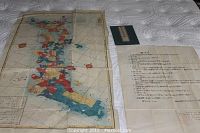 Overview of hand-colored map, Japanese letter and protective folio laid flat