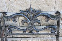 Close-up photo showing detailed Victorian fleur-de-lis design on one fencing piece.