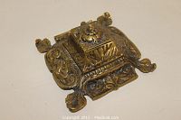 Top angled view of the square brass Victorian ink well showing intricate floral and leaf design with four corner feet.