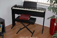 Front view of Roland EP-7 II digital piano on stand with music rest and bench underneath
