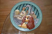 Front of the limited edition Lady and the Tramp plate with colorful embossed characters and decorative border.
