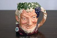 Front view of Royal Doulton Toby mug showing detailed facial features and grapevine decoration.