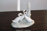 Front angle showing three geese on base with vertical natural element