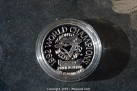 Close-up of the front side of the 1992 Toronto Blue Jays commemorative silver coin showing the team's logo, year 1992, inscriptions 'World Champions' and '.999 fine silver'.