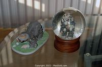 Photo of Emmett Kelly Jr. figurine and snow globe together on a table.