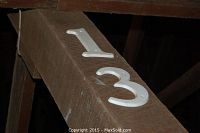 Wooden beam with number 13 indicating stall number