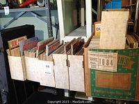 Shelf of cardboard boxes filled with assorted auto magazines