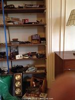 Overall shelf view with assorted items including tool chest and barometer