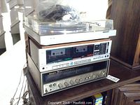 Three stacked units: turntable, cassette deck, receiver