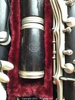 Close-up of Selmer stamp on wooden clarinet joint with red velvet lining