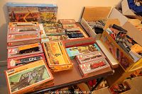 Overview photo showing multiple boxed model train cars and model kits arranged on a table.