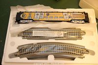 Top view of boxed Boston Bruins train car resting on foam with straight and curved track pieces beneath.