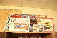 Photo of three boxed HO scale train building models placed on top of a cabinet, including Life-Like Train Station 2, Central Gas and Supply, and a building kit with parts in plastic.