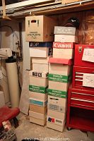 Stack of paper storage boxes containing baseball caps