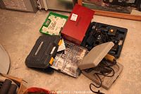 Lot of Mastercraft tools including 14.4V cordless drill, accessory cases with polishing pads and drill bits, soldering iron and other items laid out on floor.