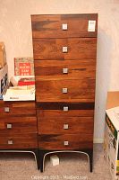 Full front view of the tall wooden dresser showing 7 drawers with silver textured square knobs.