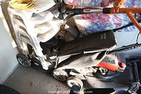 Side view of green Craftsman lawn mower showing black fabric grass collection bag and wheels