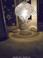 Lamp illuminated on carpet showing overall appearance