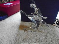Side view of figurine on carpet with box in background