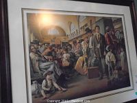 Full view of framed print showing matting, frame, and artwork depicting immigrants in a station hall