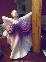 Front view of Royal Doulton Isadora figurine with ruler showing height approx 7.5 inches.
