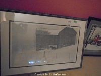 Framed print showing barn in snowy landscape