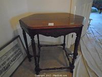 Full view of octagonal wood hall table with turned spindle legs and stretcher supports