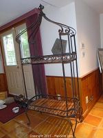 Full front view of the decorative shelving unit in a room near a door
