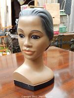 Hand painted figural head bust showing front view with facial details and hair styling.