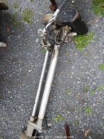 Full length view of Seagull outboard motor showing silver shaft, black handle grip and propeller assembly.