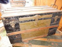 Three photos of an antique wooden steamer trunk showing front and side, highlighting metal bands, lock hardware and handles.
