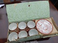 Full set of 6 cups and 6 plates in original box with cardboard dividers visible