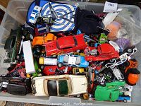 Large plastic bin filled with assorted toy cars and vehicles showing variety and colors.