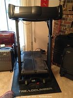 Frontal view of the TreadClimber on included black mat with ‘TREADCLIMBER’ branding