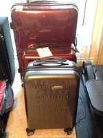 Three luggage pieces together: large red, medium red, small silver